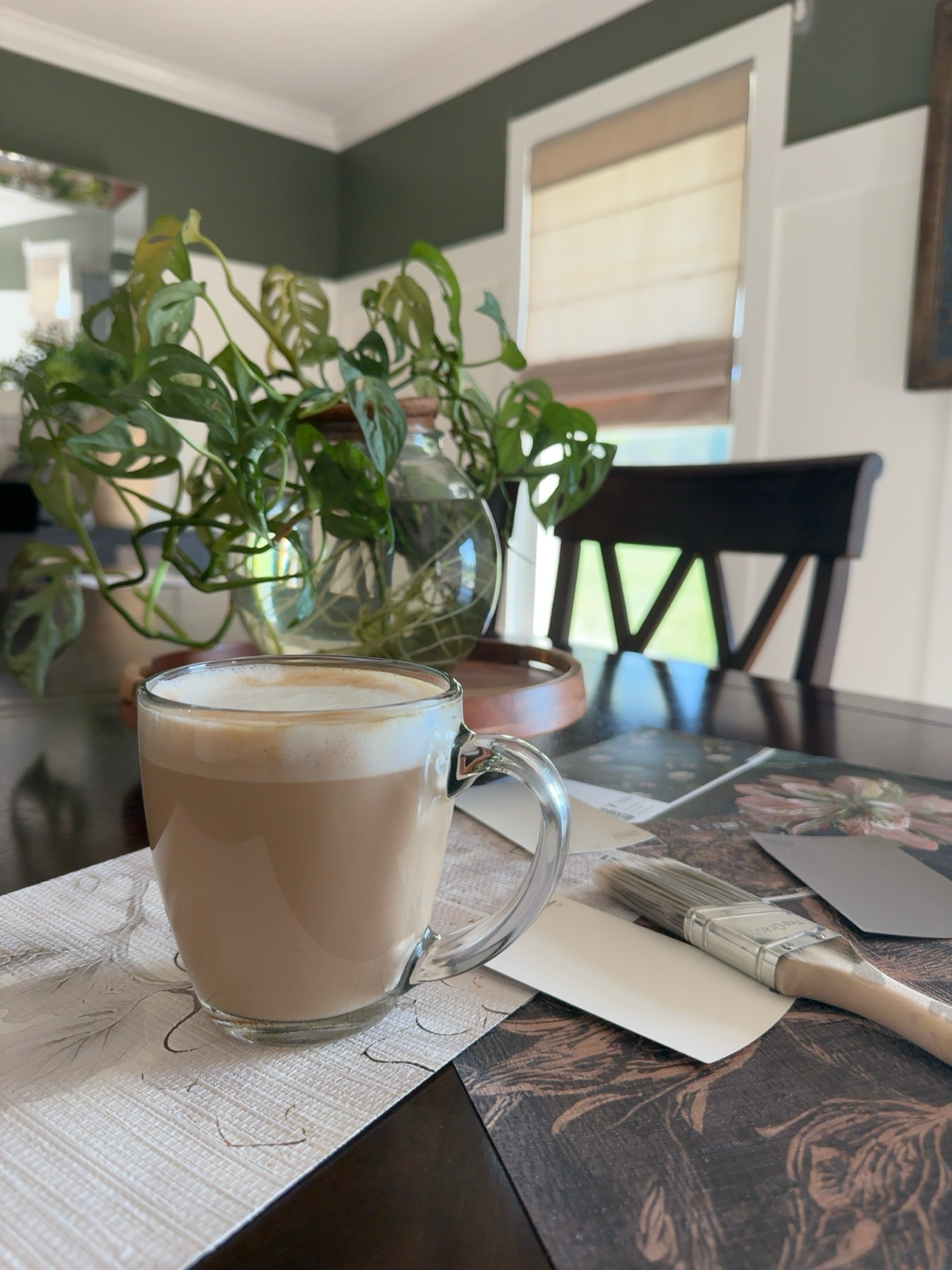 Coffee cup with paint and wallpaper samples